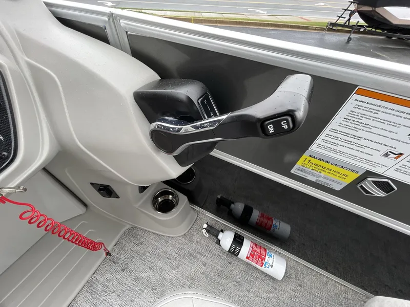 Slide: The Image of Throttle control of 2025 South Bay 222RSLE boat with safety instructions and fire extinguisher. - 24