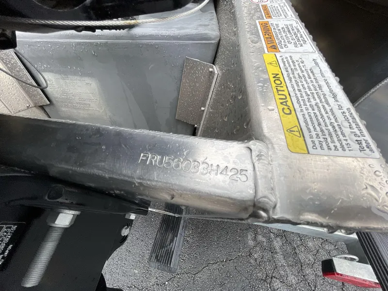 Slide: The Image of Close-up of South Bay 222RSLE 2025 boat hull identification number and caution labels. - 27