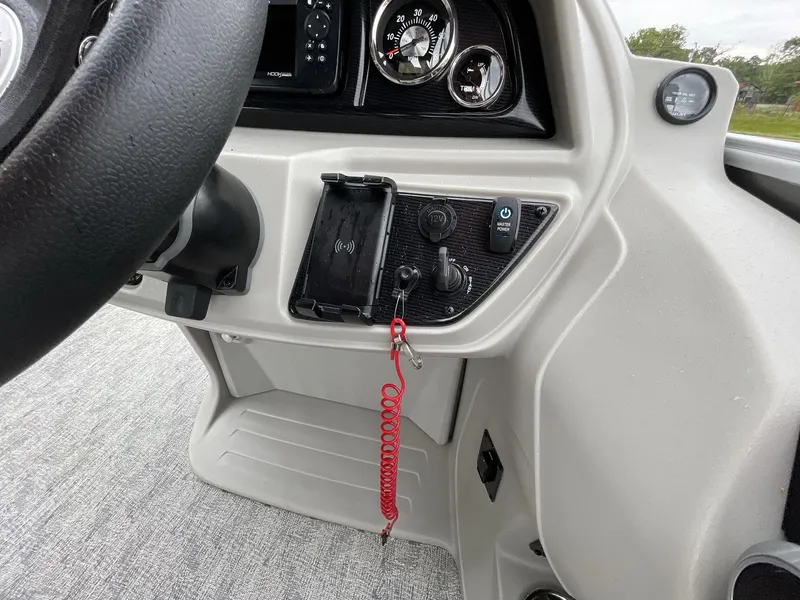 Slide: The Image of 2025 South Bay 222RSLE boat dashboard with steering wheel and control panel. - 28