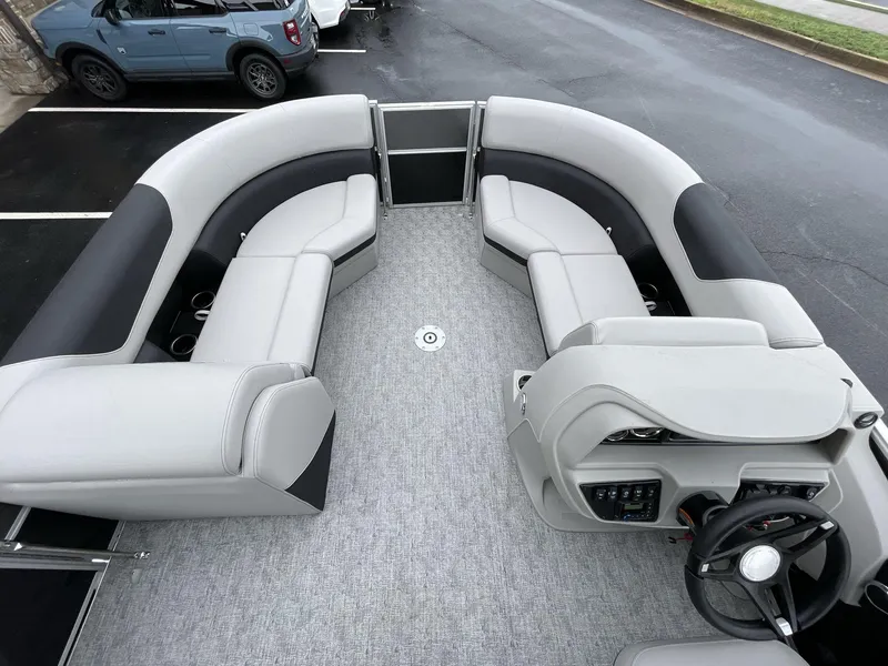 Slide: The Image of 2025 South Bay 222RSLE pontoon boat interior with gray seating and steering console. - 29