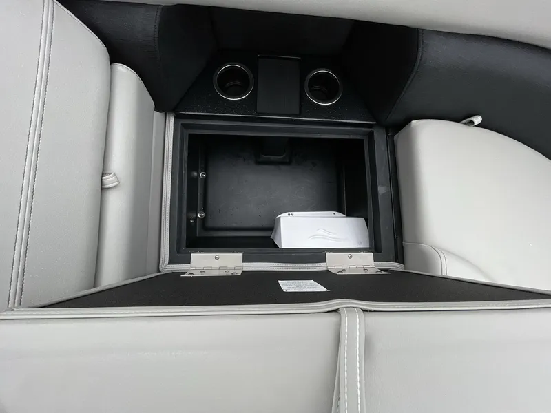 Slide: The Image of Interior storage compartment of 2025 South Bay 222RSLE with cup holders and sleek design. - 30