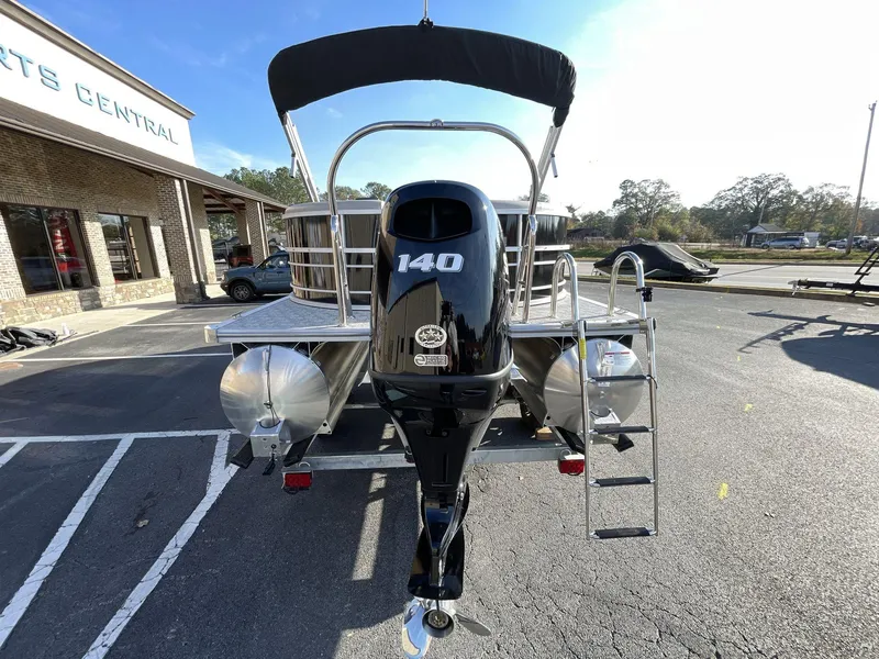 Slide: The Image of 2025 South Bay 222RSLE pontoon boat with 140 HP engine, parked outside dealership. - 5