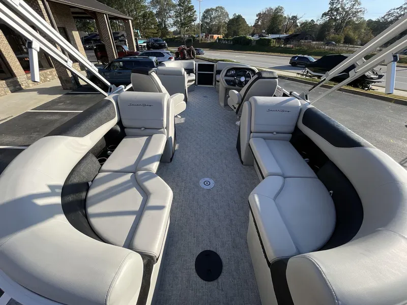 Slide: The Image of 2025 South Bay 222RSLE pontoon boat interior with plush seating and modern design. - 6
