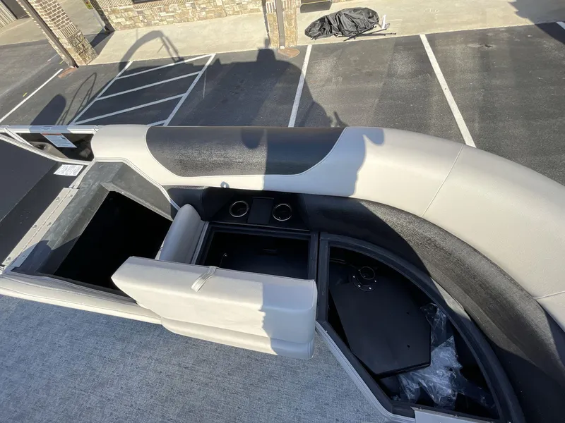 Slide: The Image of 2025 South Bay 222RSLE boat interior with seating and storage compartments. - 7