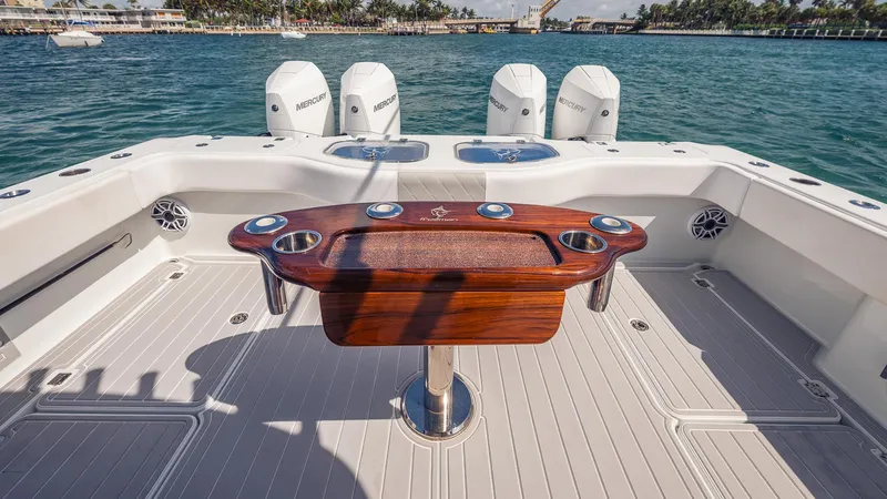 Slide: The Image of Freeman 43 boat deck with wooden table and Mercury engines, 2022 model. - 19