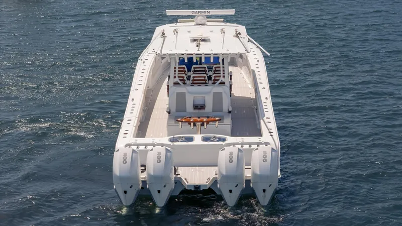 Slide: The Image of 2022 Freeman 43 boat with four engines on open water. - 2