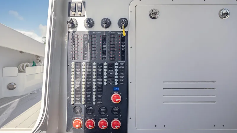 Slide: The Image of Control panel of a 2022 Freeman 43 boat, featuring switches and dials. - 23
