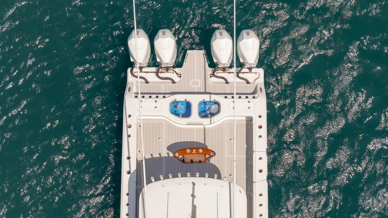Slide: The Image of Aerial view of 2022 Freeman 43 boat with four engines on blue water. - 3