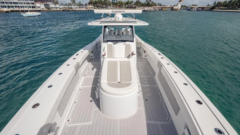 Slide: The Image of 2022 Freeman 43 boat on water, featuring spacious deck and Garmin equipment. - 6