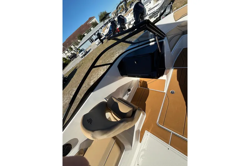 Slide: The Image of 2025 Bayliner V20 boat interior with tan seating and sleek design. - 10