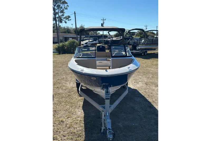 Slide: The Image of 2025 Bayliner V20 boat on trailer, parked outdoors on grass. - 3