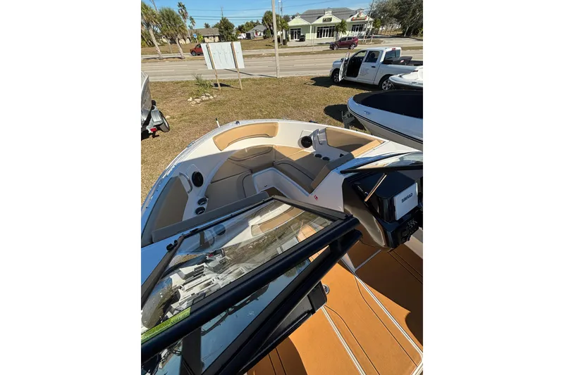 Slide: The Image of 2025 Bayliner V20 boat interior with tan seating and modern dashboard. - 8