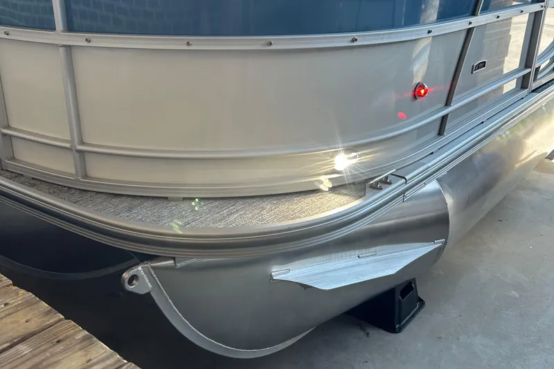 Slide: The Image of 2025 South Bay 222RSLE pontoon boat with sleek aluminum finish and LED lights. - 5