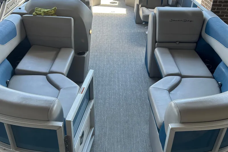 Slide: The Image of Interior of 2025 South Bay 222RSLE pontoon boat with blue and gray seating. - 7