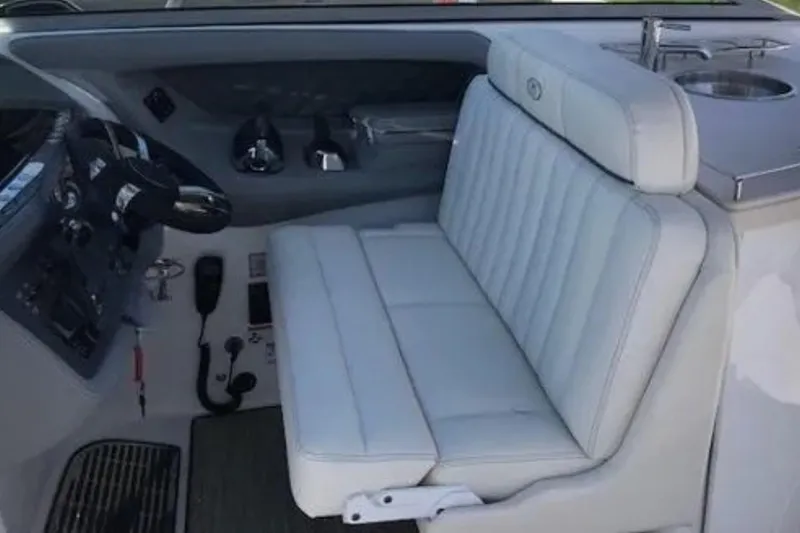 Slide: The Image of Interior of a 2018 Cobalt R35 boat with white seating and control panel. - 10