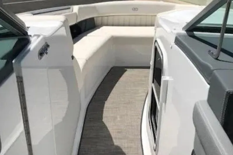 Slide: The Image of 2018 Cobalt R35 boat interior with white seating and carpeted floor. - 17