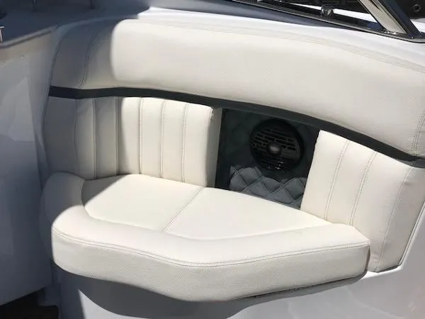 Slide: The Image of 2018 Cobalt R35 boat interior with white cushioned seating and built-in speaker. - 5