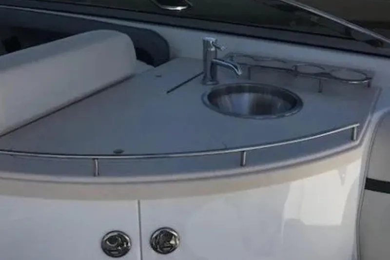 Slide: The Image of 2018 Cobalt R35 boat interior with sink and cup holders. - 7