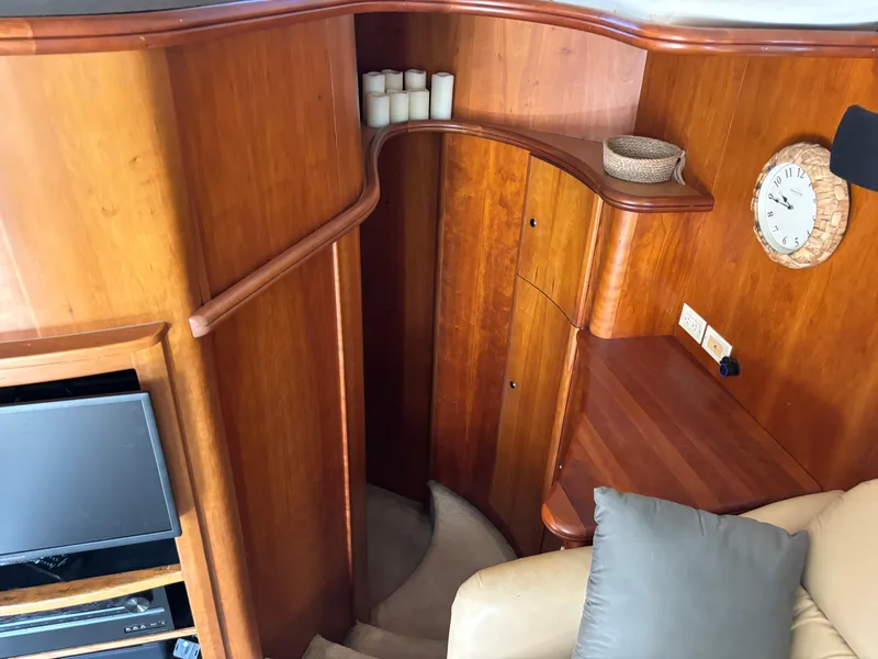Slide: The Image of Interior of 2001 Silverton 410 Sport Bridge with leather chair and wooden accents. - 10