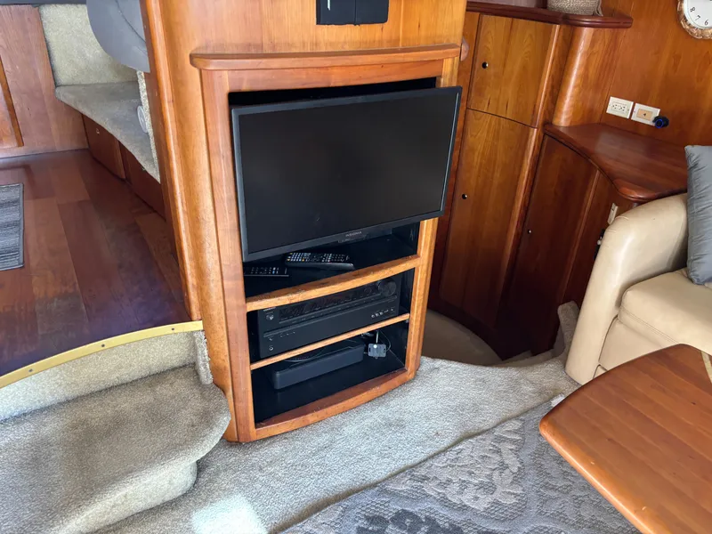 Slide: The Image of Luxurious interior of 2001 Silverton 410 Sport Bridge with beige leather seating and wooden table. - 11