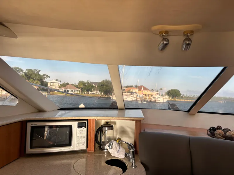 Slide: The Image of 2001 Silverton 410 Sport Bridge kitchen with microwave, stove, and sink. - 18