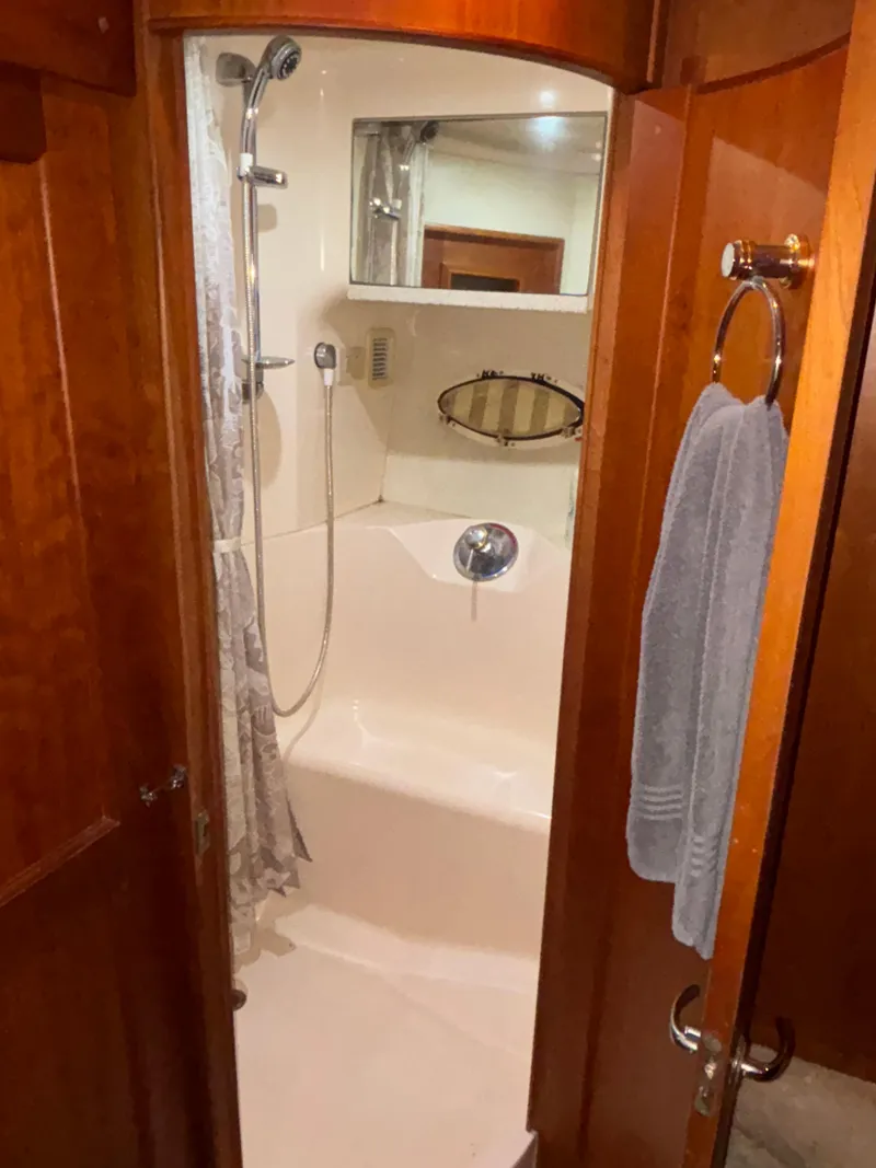 Slide: The Image of Cozy cabin bedroom in 2001 Silverton 410 Sport Bridge yacht with wooden accents. - 28