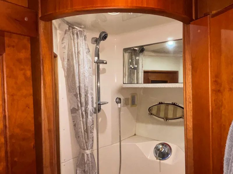Slide: The Image of Cozy cabin interior of 2001 Silverton 410 Sport Bridge with porthole and anchor decor. - 29