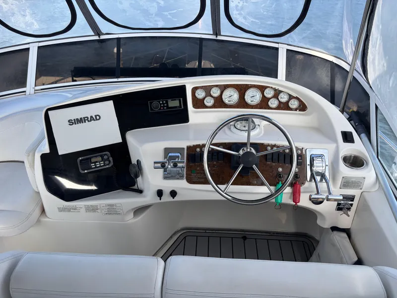 Slide: The Image of 2001 Silverton 410 Sport Bridge yacht docked with inflatable boat, clear sky background. - 3