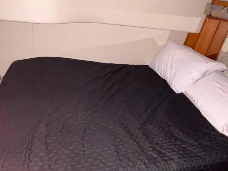 Slide: The Image of 2001 Silverton 410 Sport Bridge bathroom with shower, wooden cabinetry, and towel rack. - 30