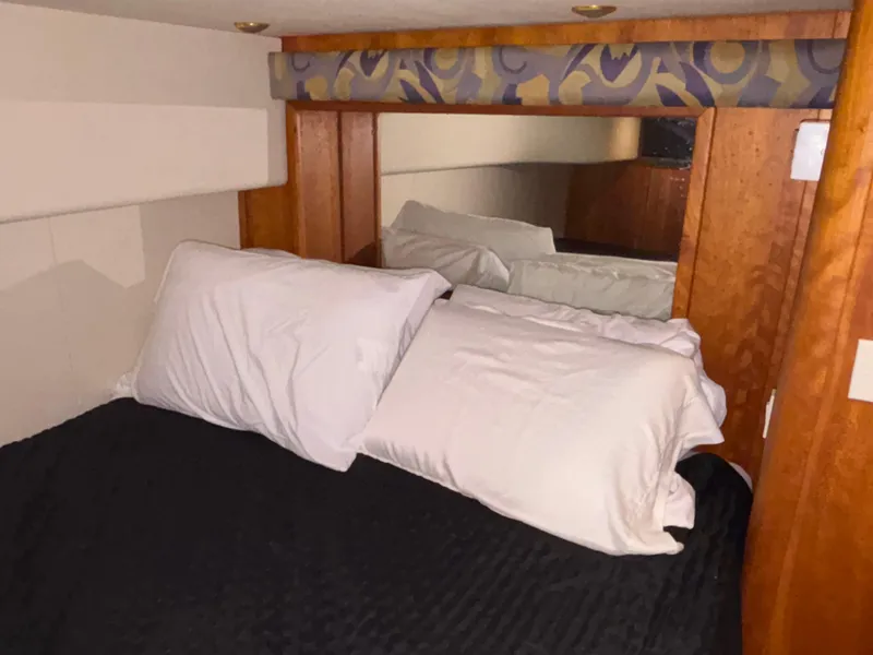 Slide: The Image of Bathroom interior of 2001 Silverton 410 Sport Bridge with shower and wooden accents. - 31