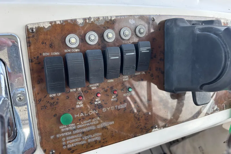 Slide: The Image of Control panel of a 2001 Silverton 410 Sport Bridge boat with various switches and indicators. - 43