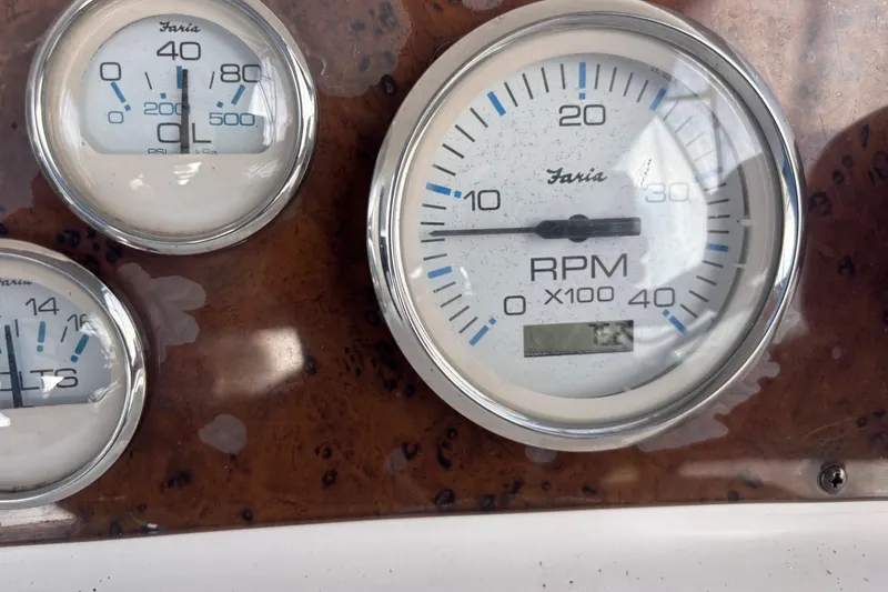 Slide: The Image of Close-up of 2001 Silverton 410 Sport Bridge dashboard gauges, including RPM and oil pressure. - 47