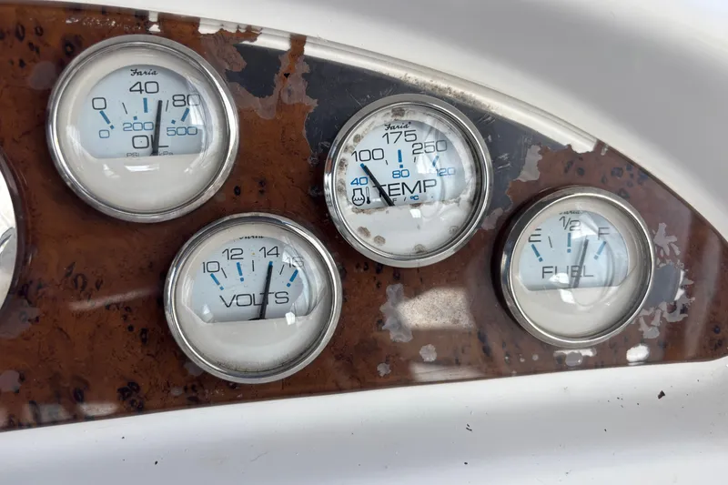 Slide: The Image of Dashboard gauges of a 2001 Silverton 410 Sport Bridge boat, showing pressure, temperature, volts, and fuel. - 50