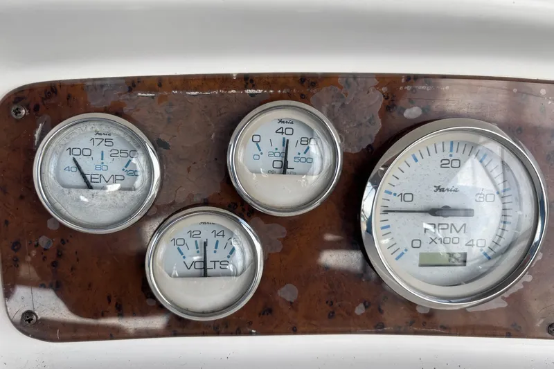Slide: The Image of Close-up of 2001 Silverton 410 Sport Bridge gauges, displaying temperature, voltage, and RPM. - 51