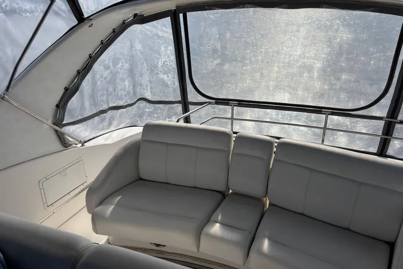 Slide: The Image of Interior of 2001 Silverton 410 Sport Bridge with white leather seating and large windows. - 57