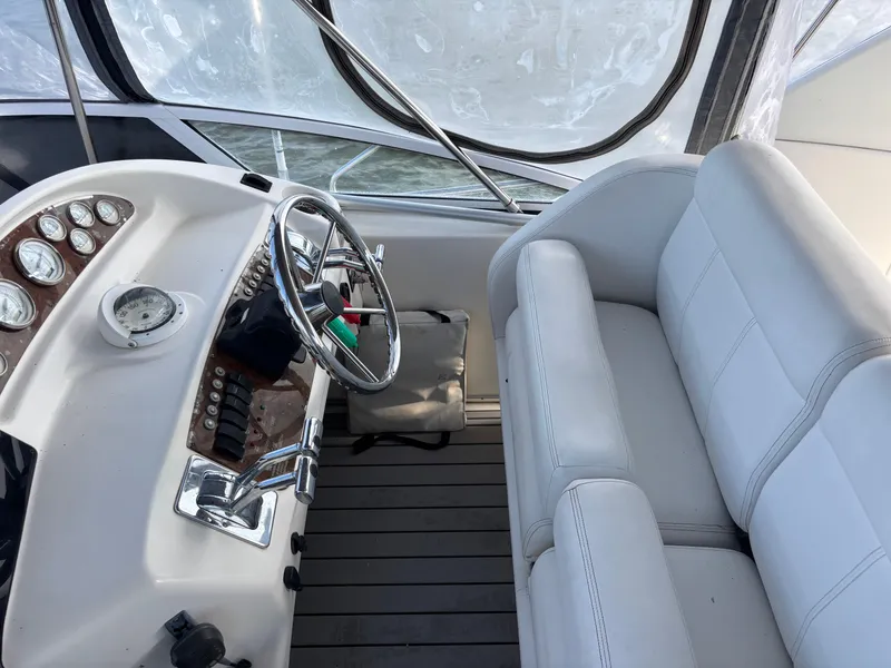Slide: The Image of Interior of 2001 Silverton 410 Sport Bridge with leather seating and panoramic windows. - 6
