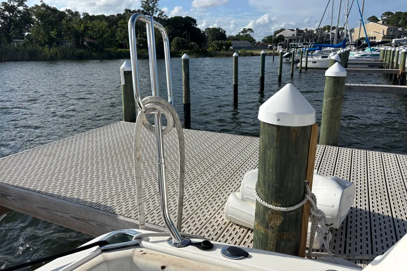 Slide: The Image of 2001 Silverton 410 Sport Bridge docked at a marina with clear skies. - 63