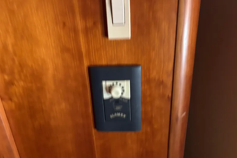 Slide: The Image of Wooden interior panel with a control switch on a 2001 Silverton 410 Sport Bridge. - 67