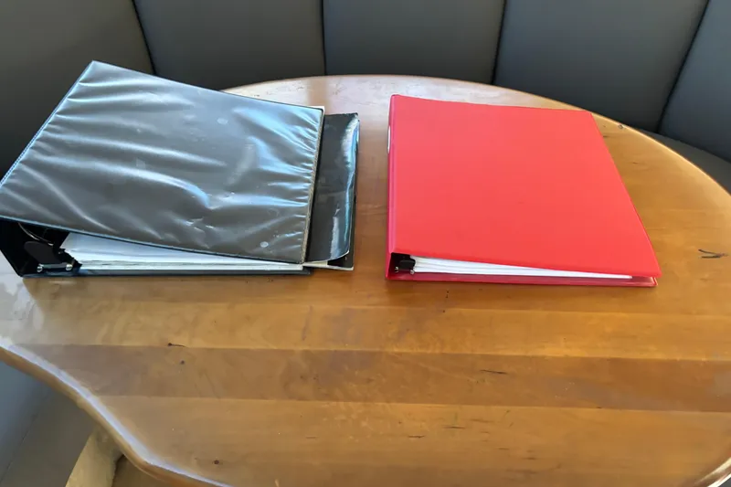 Slide: The Image of Two binders on a wooden table, related to a 2001 Silverton 410 Sport Bridge. - 68