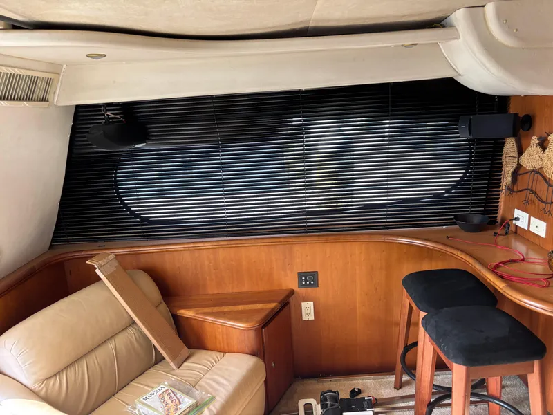 Slide: The Image of 2001 Silverton 410 Sport Bridge interior with white seating and Simrad navigation system. - 7