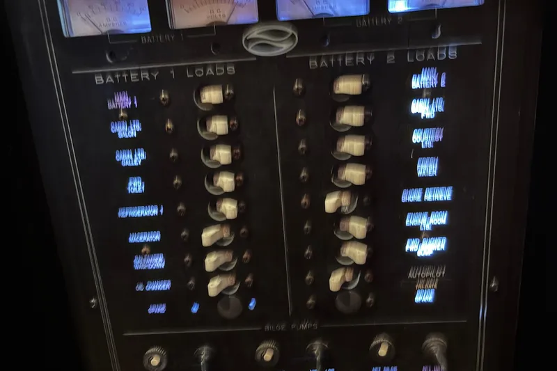 Slide: The Image of Control panel of a 2001 Silverton 410 Sport Bridge boat, showing battery loads and switches. - 71