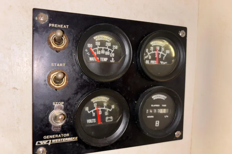 Slide: The Image of Westerbeke generator control panel with gauges on a 2001 Silverton 410 Sport Bridge. - 76