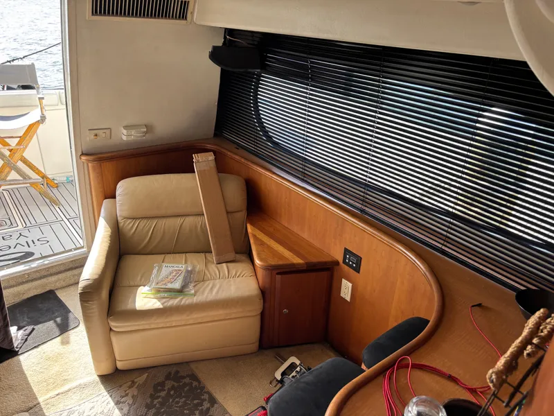 Slide: The Image of 2001 Silverton 410 Sport Bridge helm with steering wheel and white seating. - 8