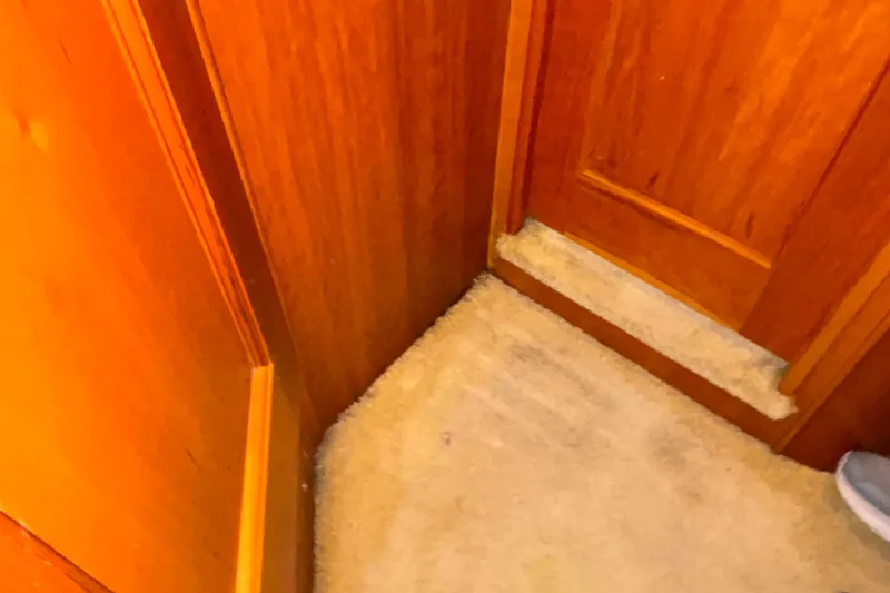 Slide: The Image of Interior of 2001 Silverton 410 Sport Bridge with wooden paneling and carpeted floor. - 82