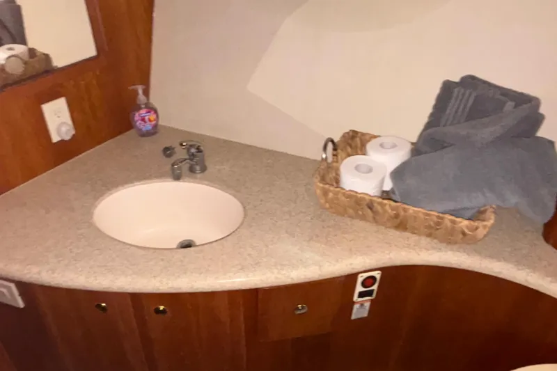 Slide: The Image of 2001 Silverton 410 Sport Bridge bathroom with sink, toiletries, and towels. - 87