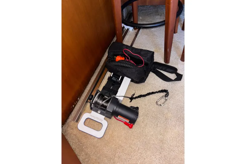 Slide: The Image of 2001 Silverton 410 Sport Bridge interior with boating equipment on carpeted floor. - 90