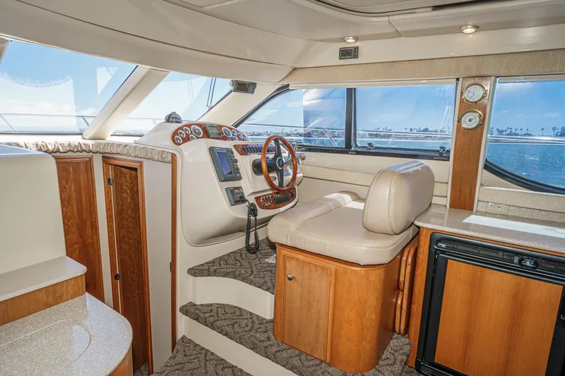 Slide: The Image of Interior of 2003 Meridian 341 Sedan yacht with helm, wooden cabinetry, and ocean view. - 10