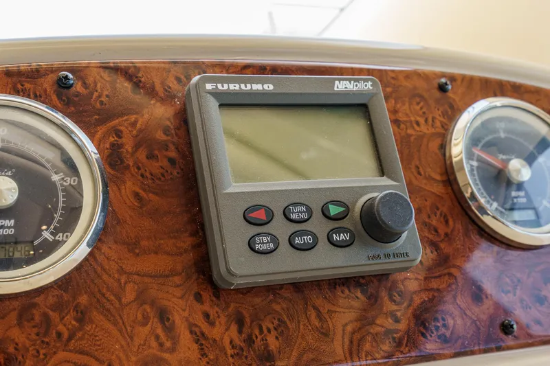 Slide: The Image of Dashboard of a 2003 Meridian 341 Sedan with Furuno NAVpilot and gauges. - 12