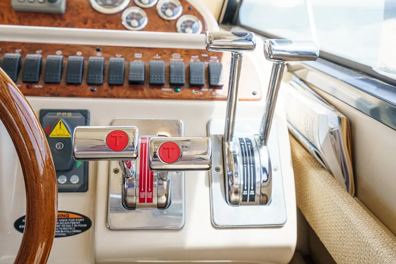 Slide: The Image of Control panel of a 2003 Meridian 341 Sedan boat with throttle levers and gauges. - 14