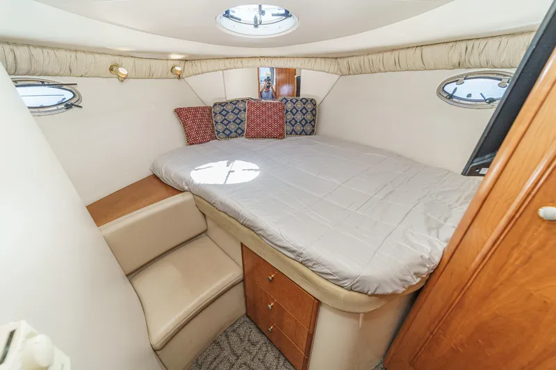 Slide: The Image of Cozy bedroom in 2003 Meridian 341 Sedan yacht with plush bedding and porthole windows. - 15